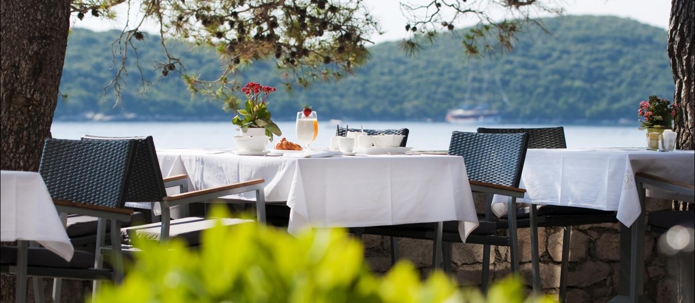 Outdoor dining overlooking the water at Lesic Demitri Palace in Croatia