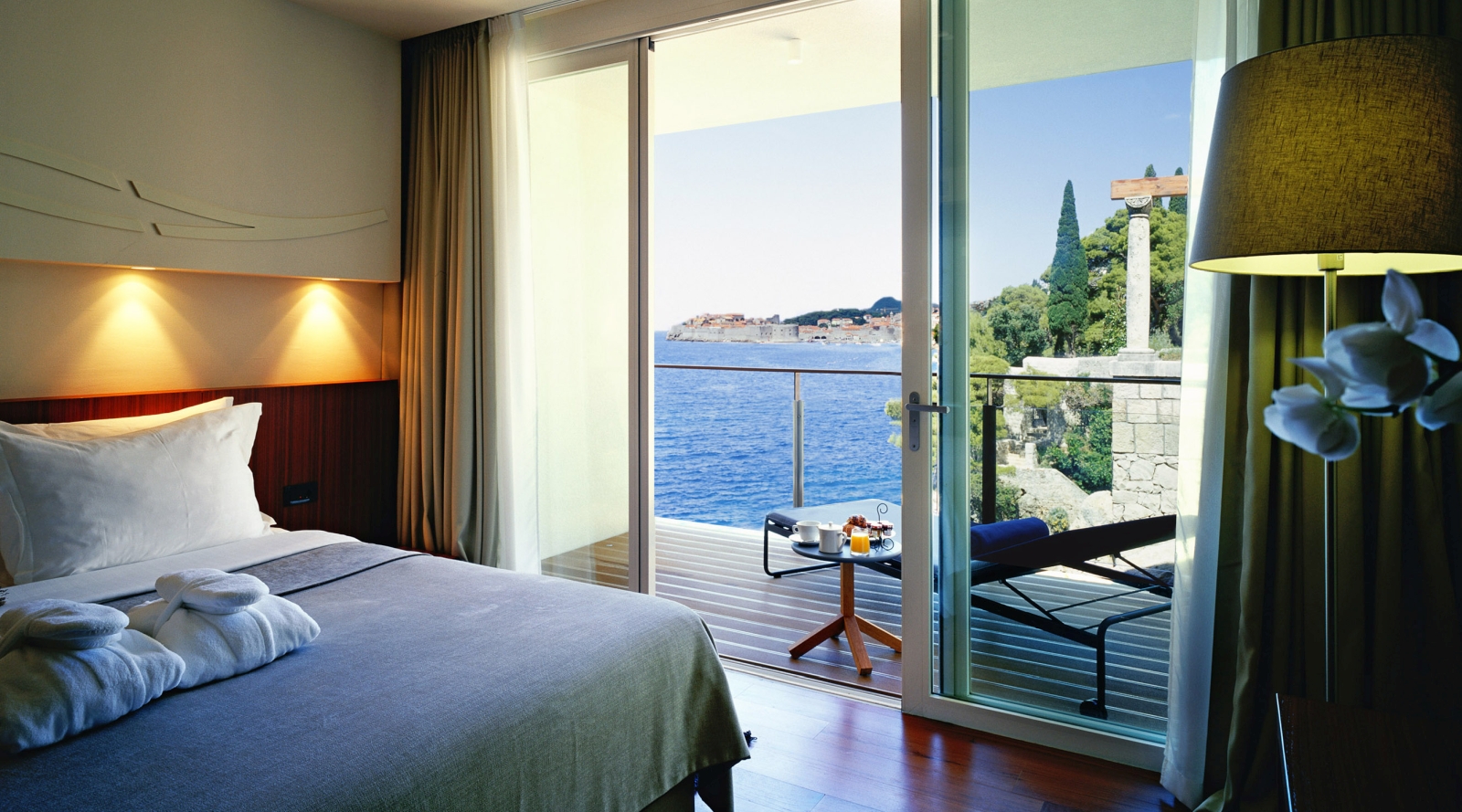 Bedroom of a Loft Suite with private balcony overlooking the Mediterranean Sea and Dubrovnik at luxury hotel Villa Dubrovnik in Croatia