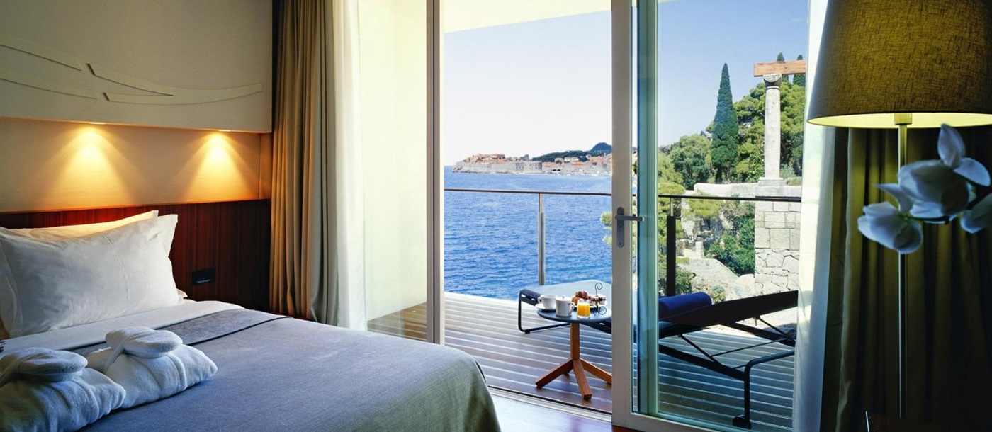 Bedroom of a Loft Suite with private balcony overlooking the Mediterranean Sea and Dubrovnik at luxury hotel Villa Dubrovnik in Croatia