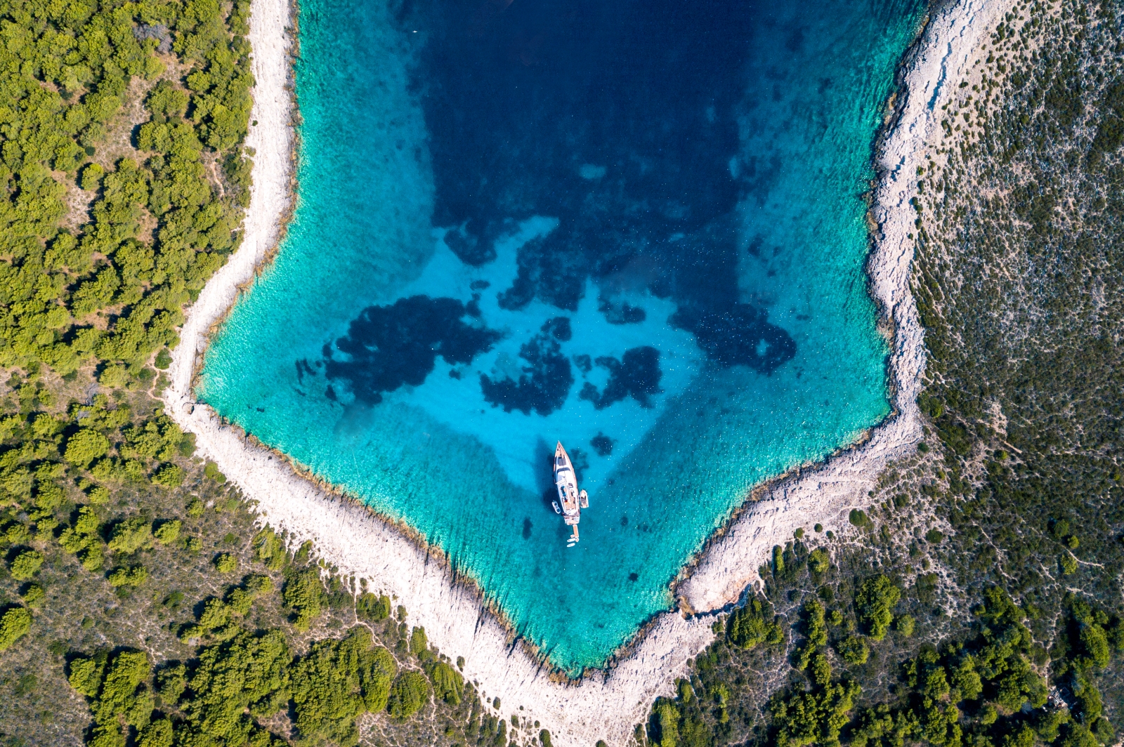 Aerial of cover with singular boat in the middle