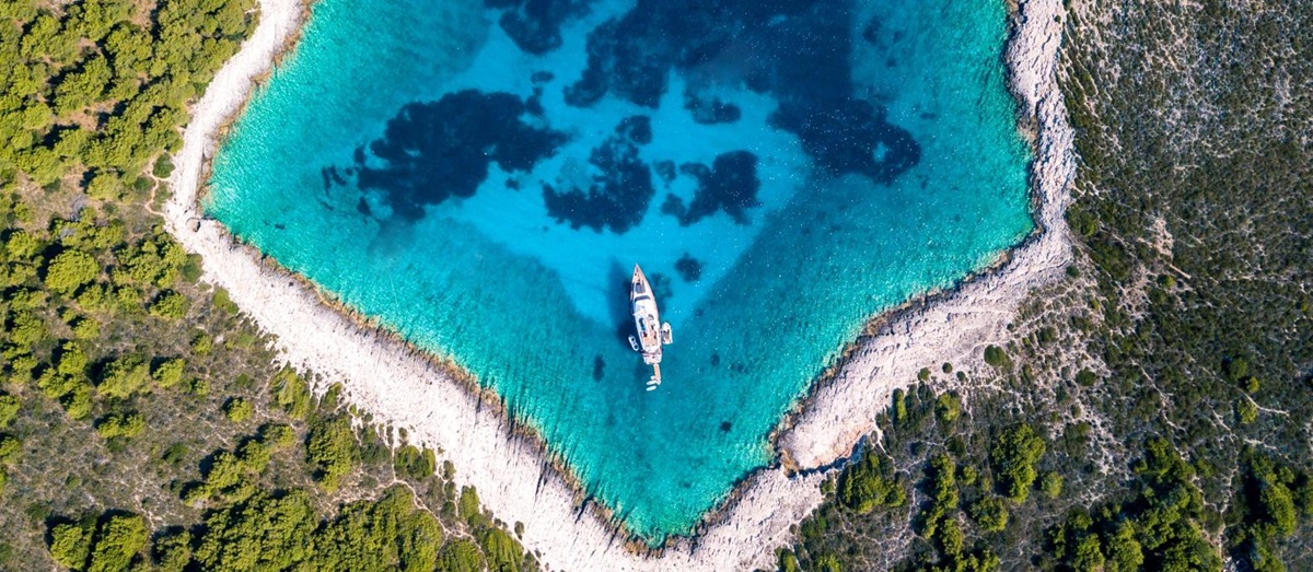 Aerial of cover with singular boat in the middle