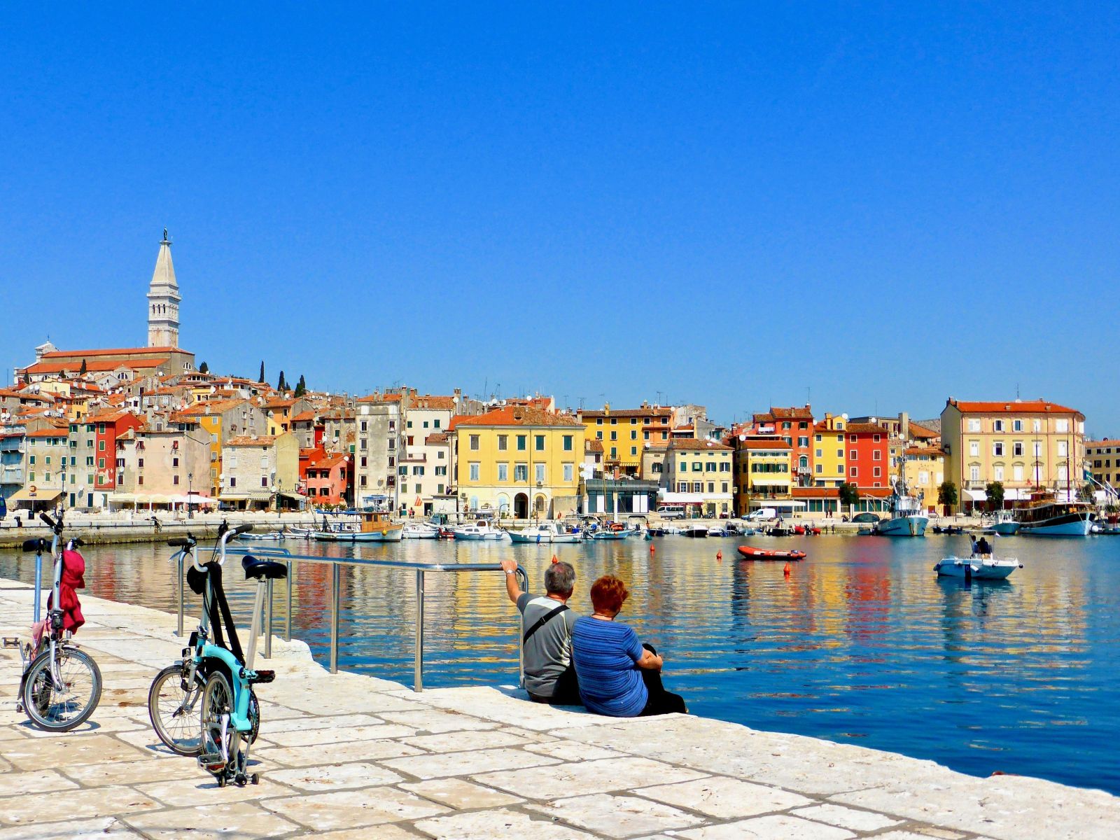 Couple admiring the views in an historic harbour in Croatia