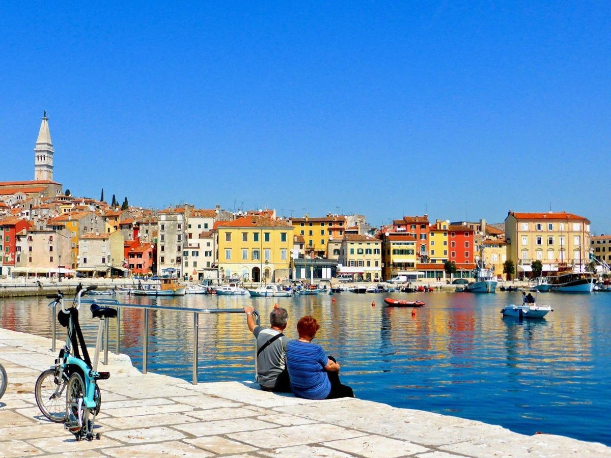 Couple admiring the views in an historic harbour in Croatia