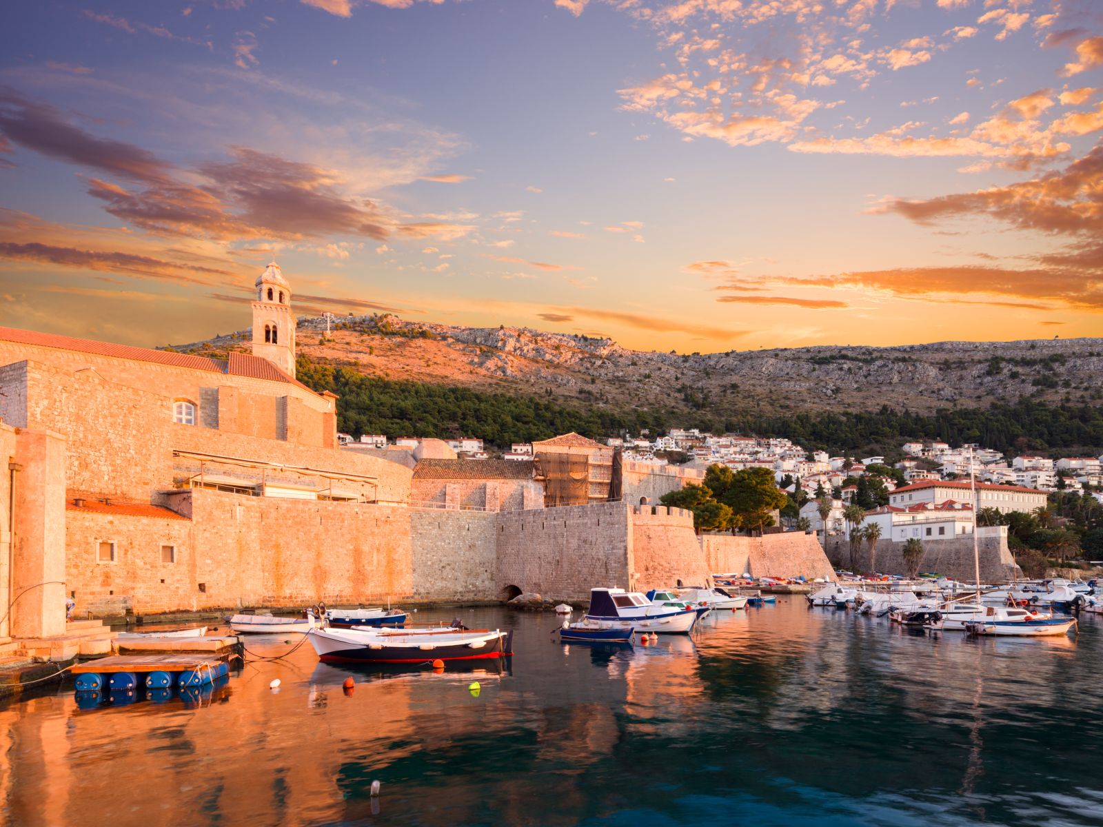 Dubrovnik harbour and boats bathed in the evening light in Croatia