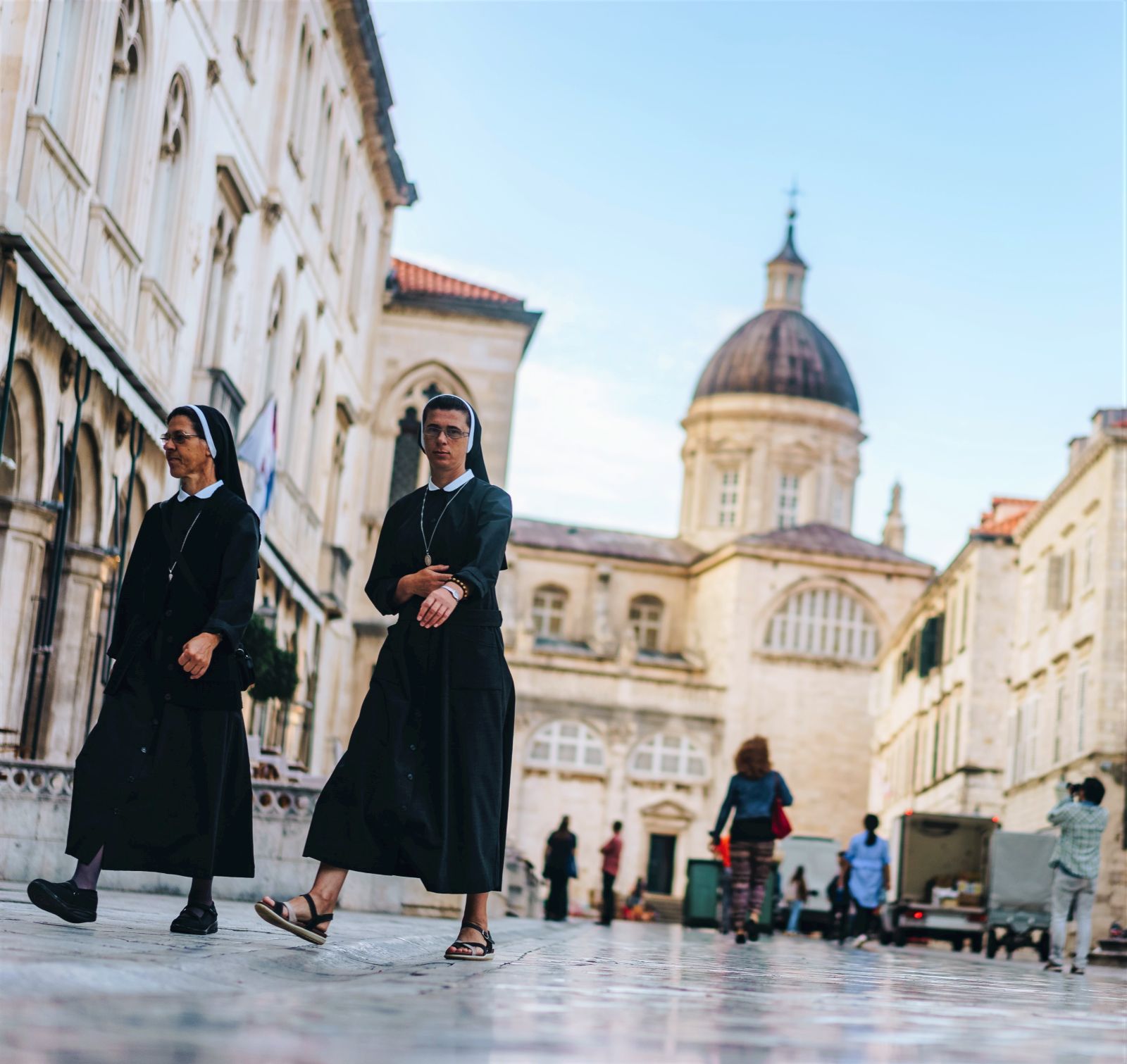 Two nuns walking through a square in Dubrovnik old town, Croatia