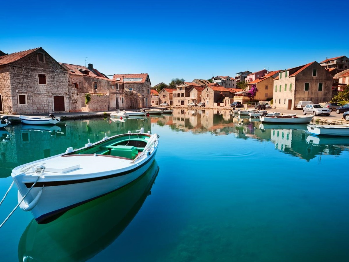 Fishing boat in still blue waters in Hvar Harbour, Croatia