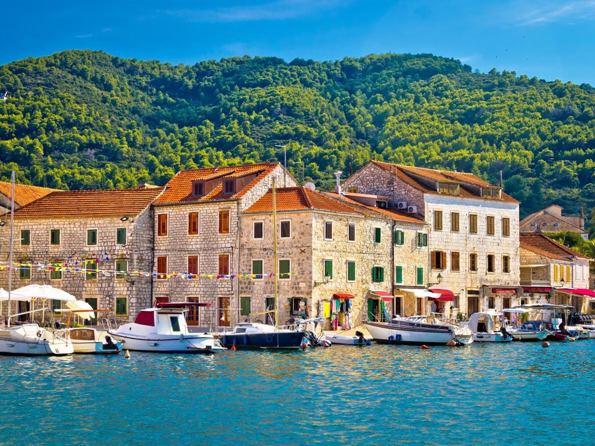The waterfront of Hvar in Croatia with forested hills in the background
