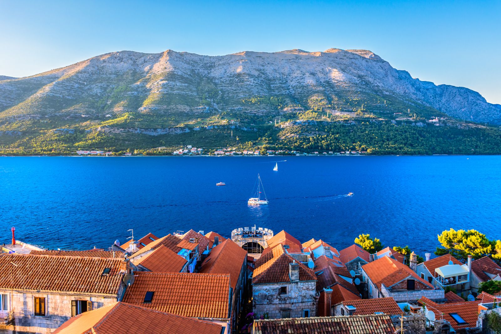 Aerial view of Korcula Bay in Croatia with terracotta rooftops and hills beyond