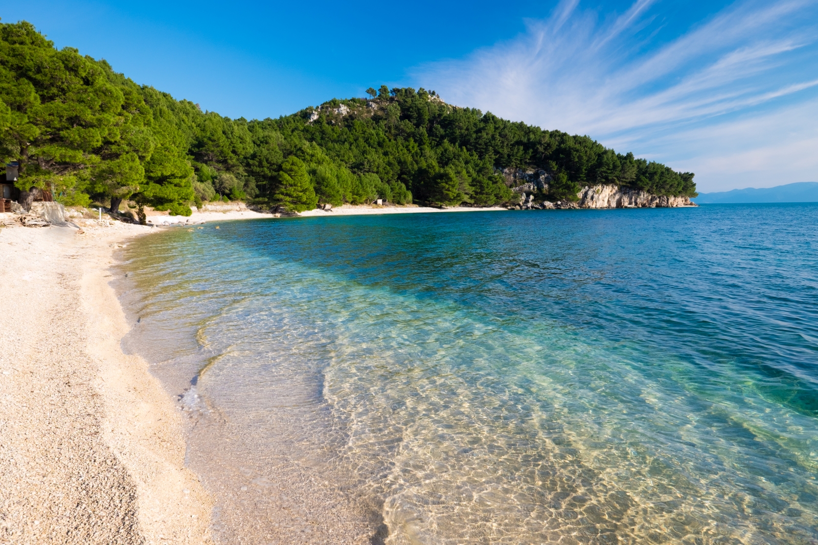 Empty beach with curving coast