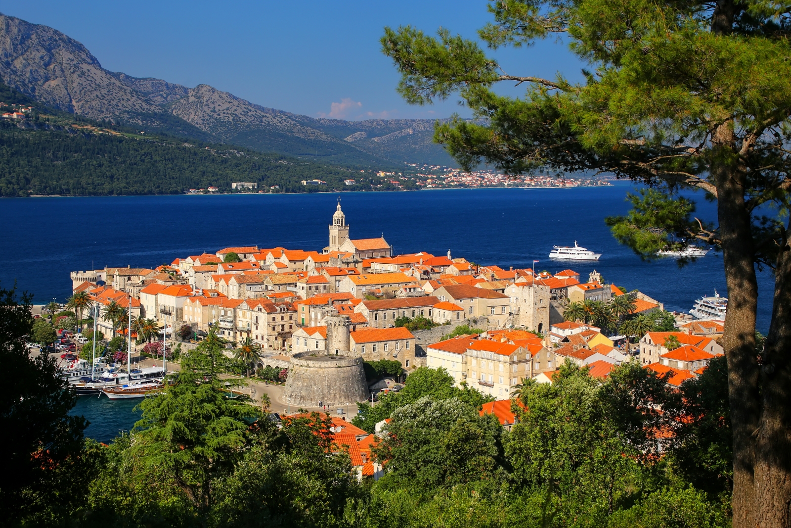 Town with orange roofs and sea in the background