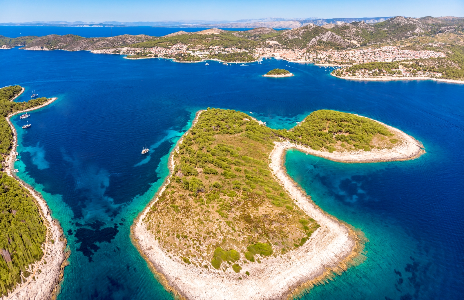 Aerial of group of islands with boats