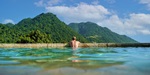 Guest enjoying mountain views from the infinity pool at Jungle Bay Dominica