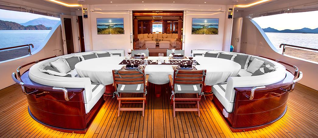 Stylish outdoor dining area on the Aqua Mare superyacht in Galapagos