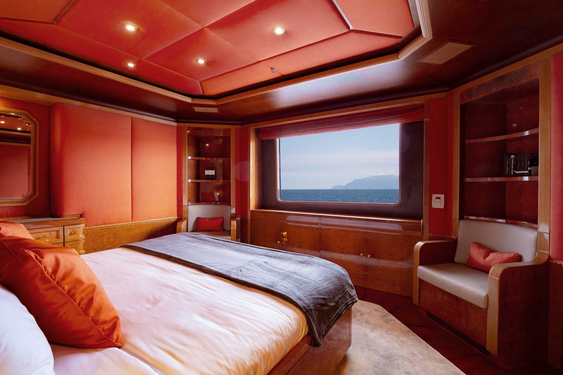 Red guest cabin with sea views onboard the Aqua Mare luxury expedition cruiser in the Galapagos Islands