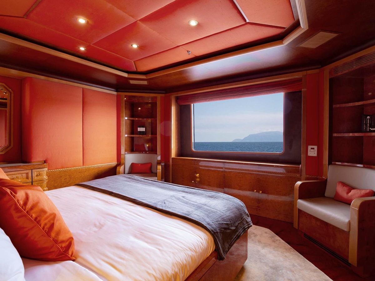 Red guest cabin with sea views onboard the Aqua Mare luxury expedition cruiser in the Galapagos Islands