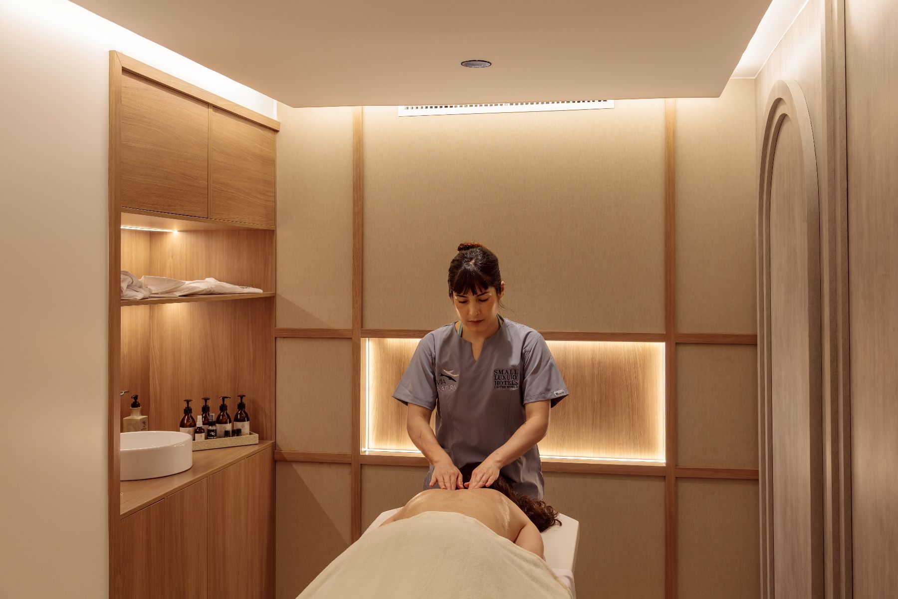 Therapist carrying out a massage for a guest on board the Hermes Galapagos luxury catamaran