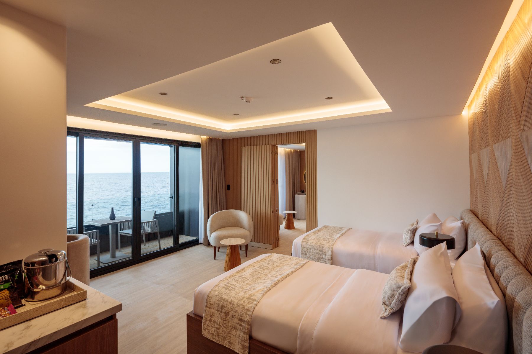 Spacious suite with twin beds and balcony on the Hermes Galapagos luxury catamaran