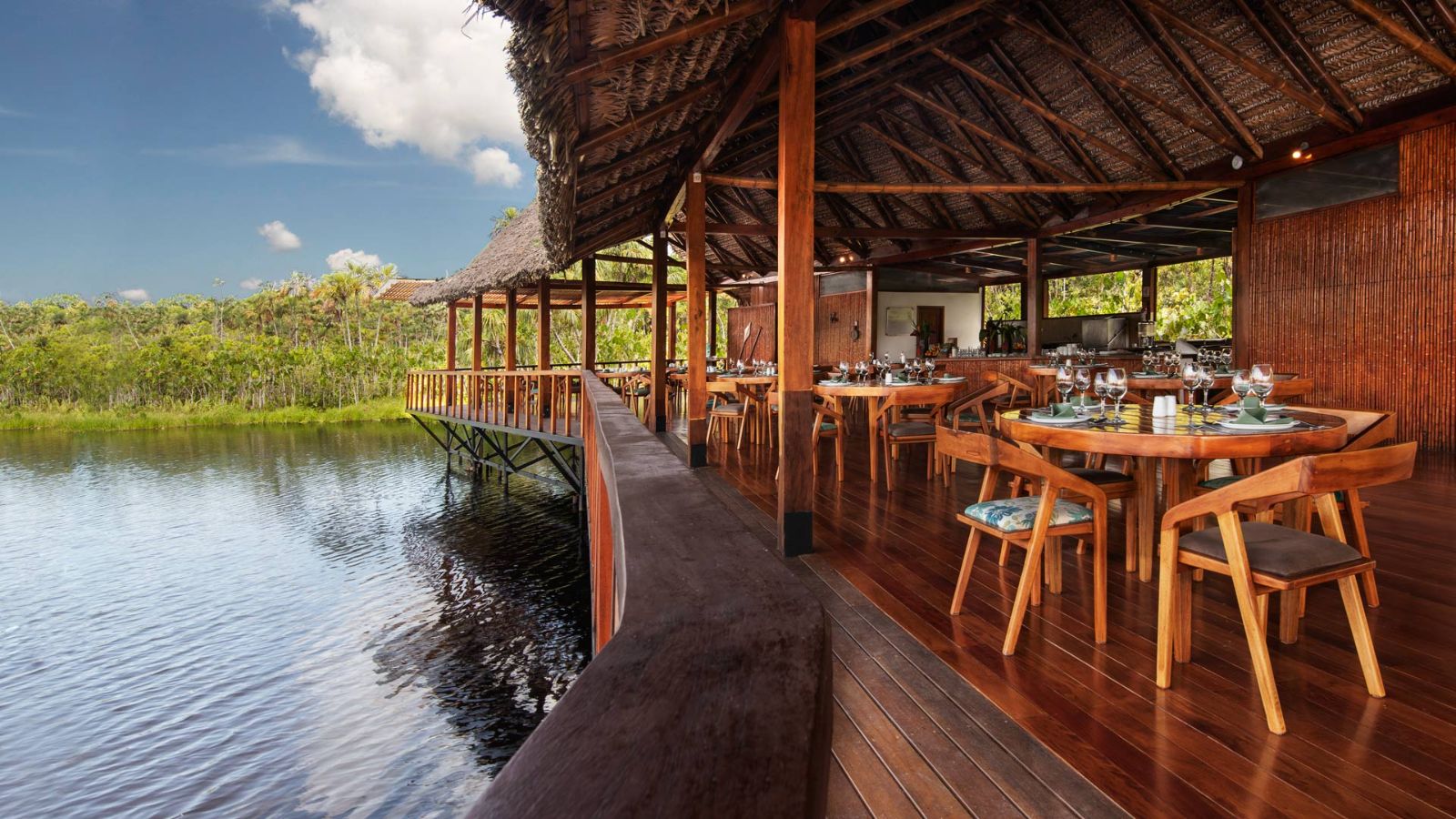 Outside dining by the waters edge at Sacha Lodge in the Amazon Rainforest, Ecuador