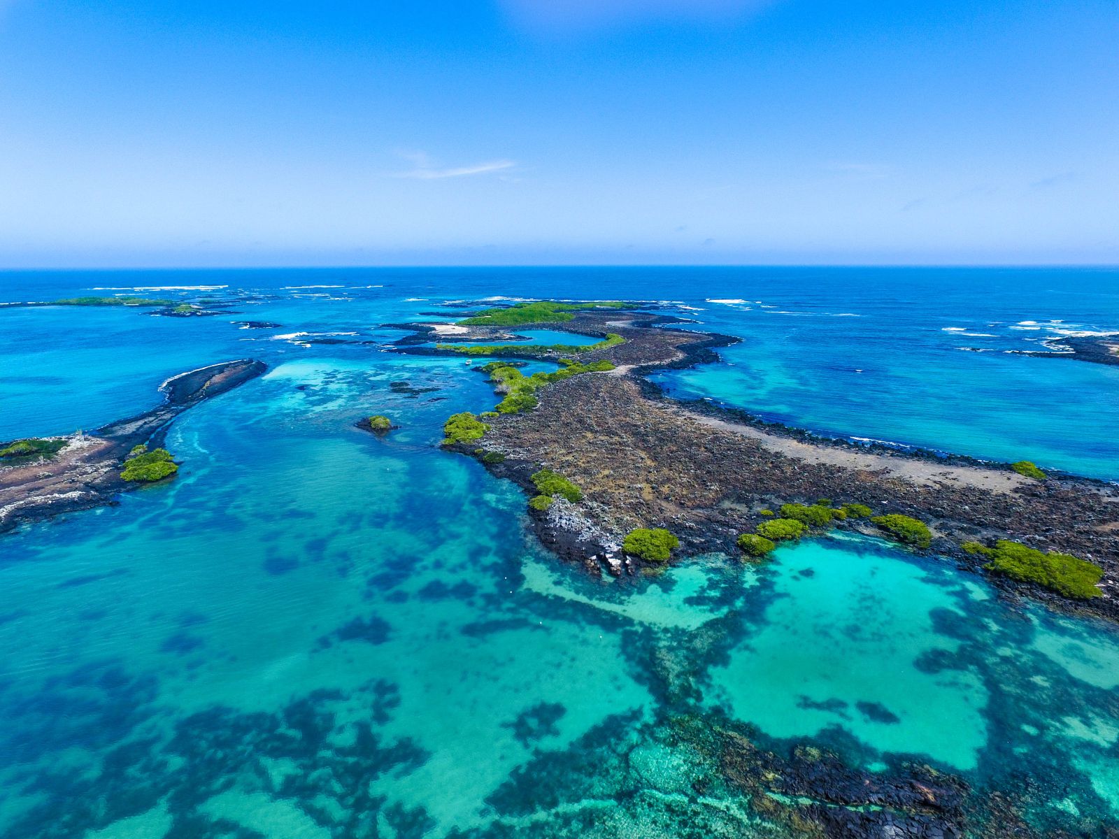 Aerial view of the crystal waters and volcanic islands of the Galapagos archipelago