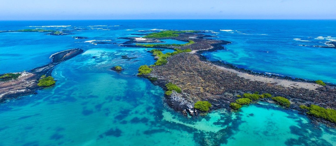 Aerial view of the crystal waters and volcanic islands of the Galapagos archipelago