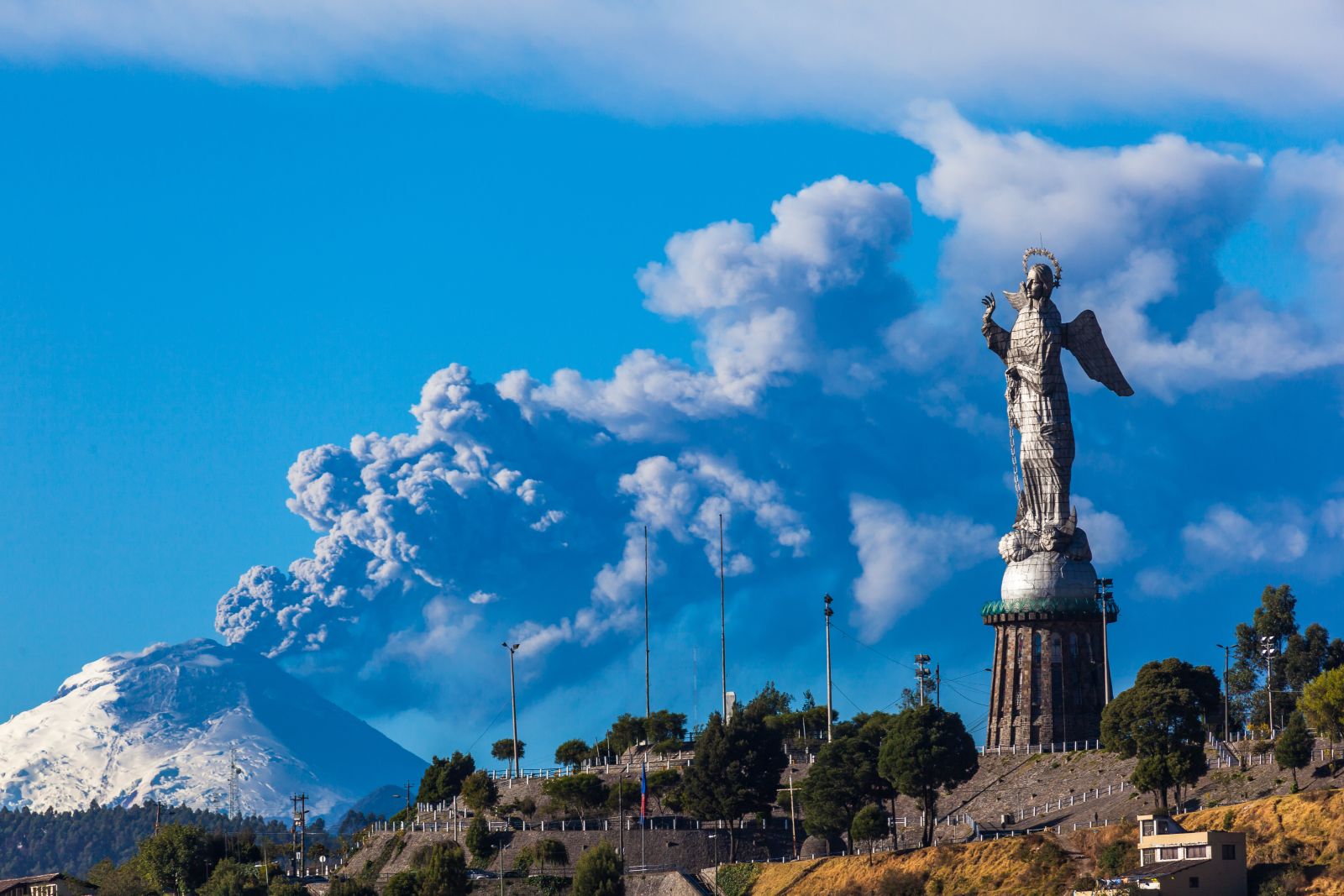 The statue of the Virgin Mary on Panecillo Hill in Quito with a volcano in the background