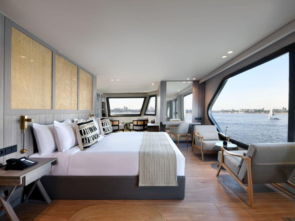 Guest suite bedroom with views onboard the Historia boutique Nile cruise hotel in Egypt