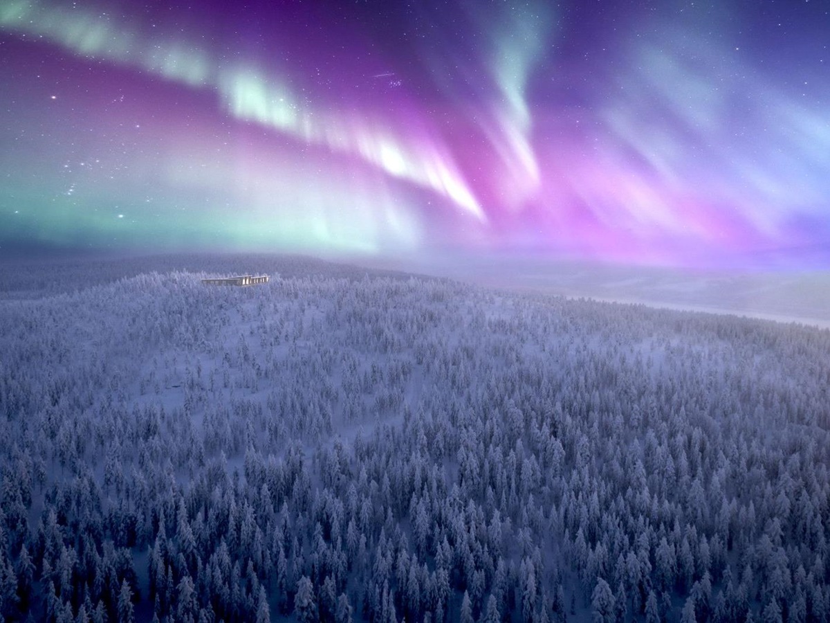 Distant view of Octola lodge iunder the Northern Lights in Lapland Finland