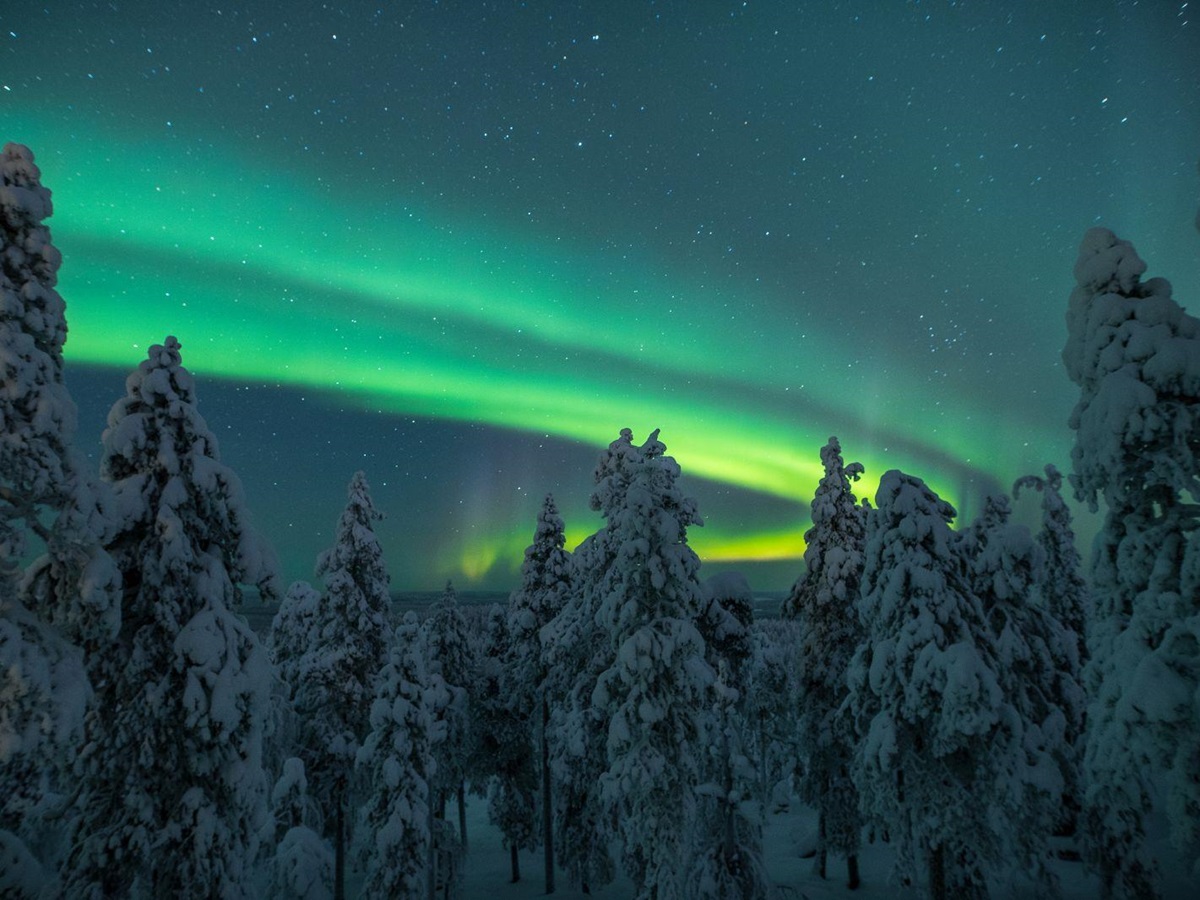 View of the Northern Lights from Octola wilderness lodge in Lapland Finland