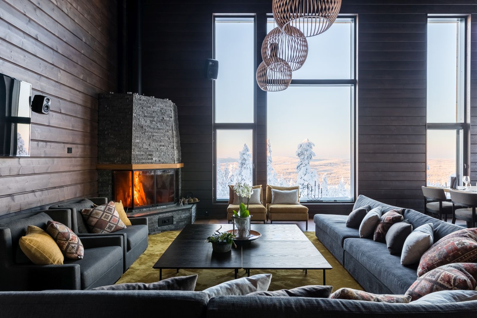 Lounge and fireplace at Octola  wilderness lodge in Lapland Finland