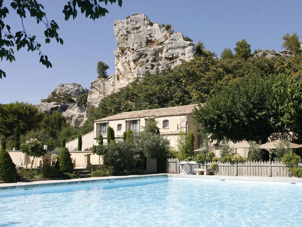 Outdoor swimming pool and facade of Baumaniere, France
