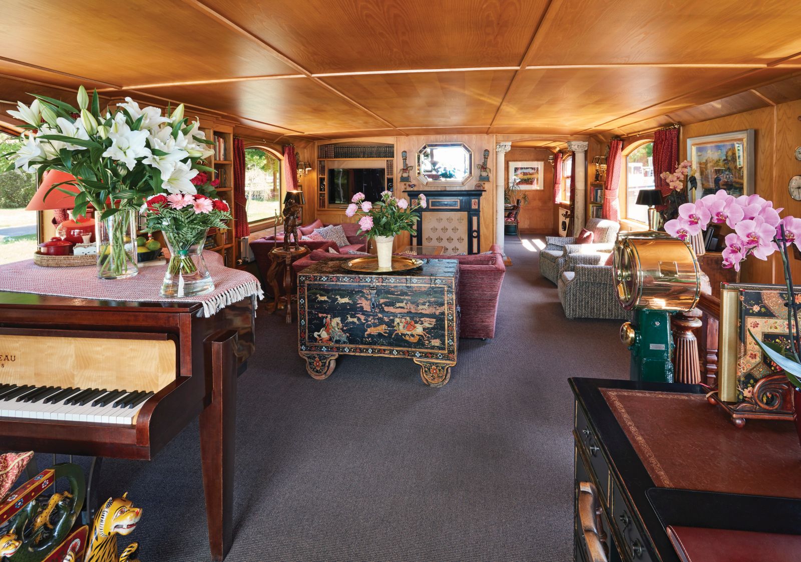 Lounge and grand piano on board the Belmond Fleur de Lys river barge in France