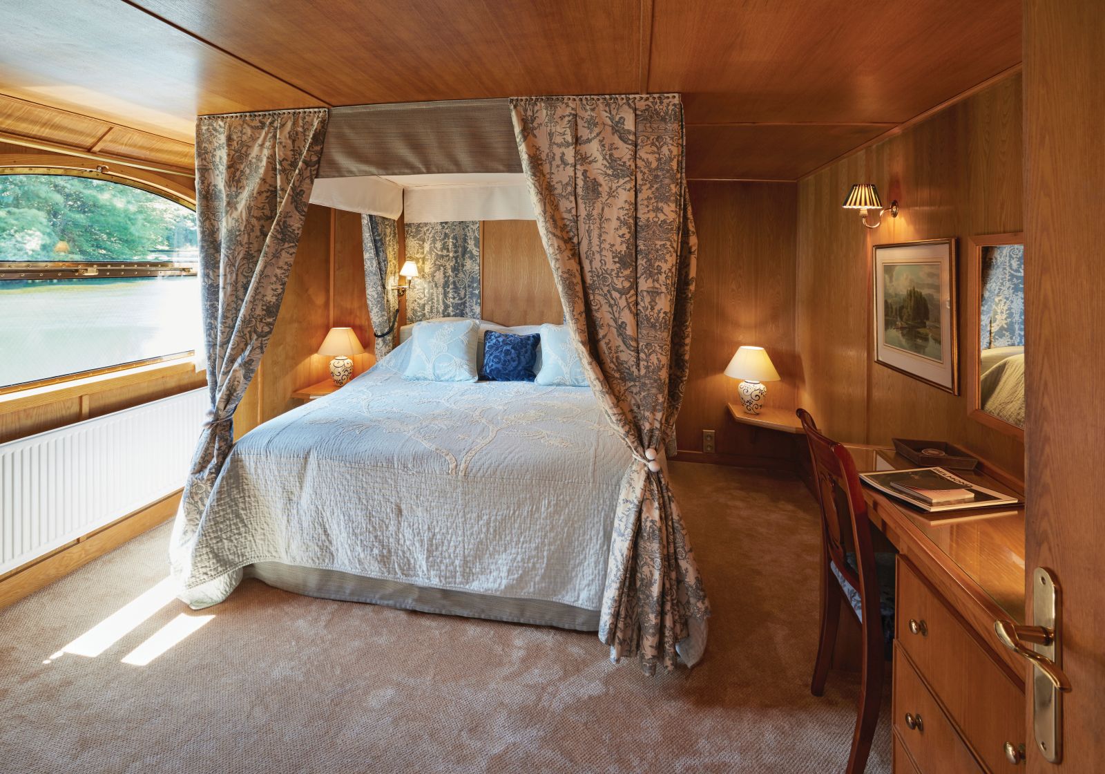 Cabin and river view on board the Belmond Fleur de Lys river barge in France