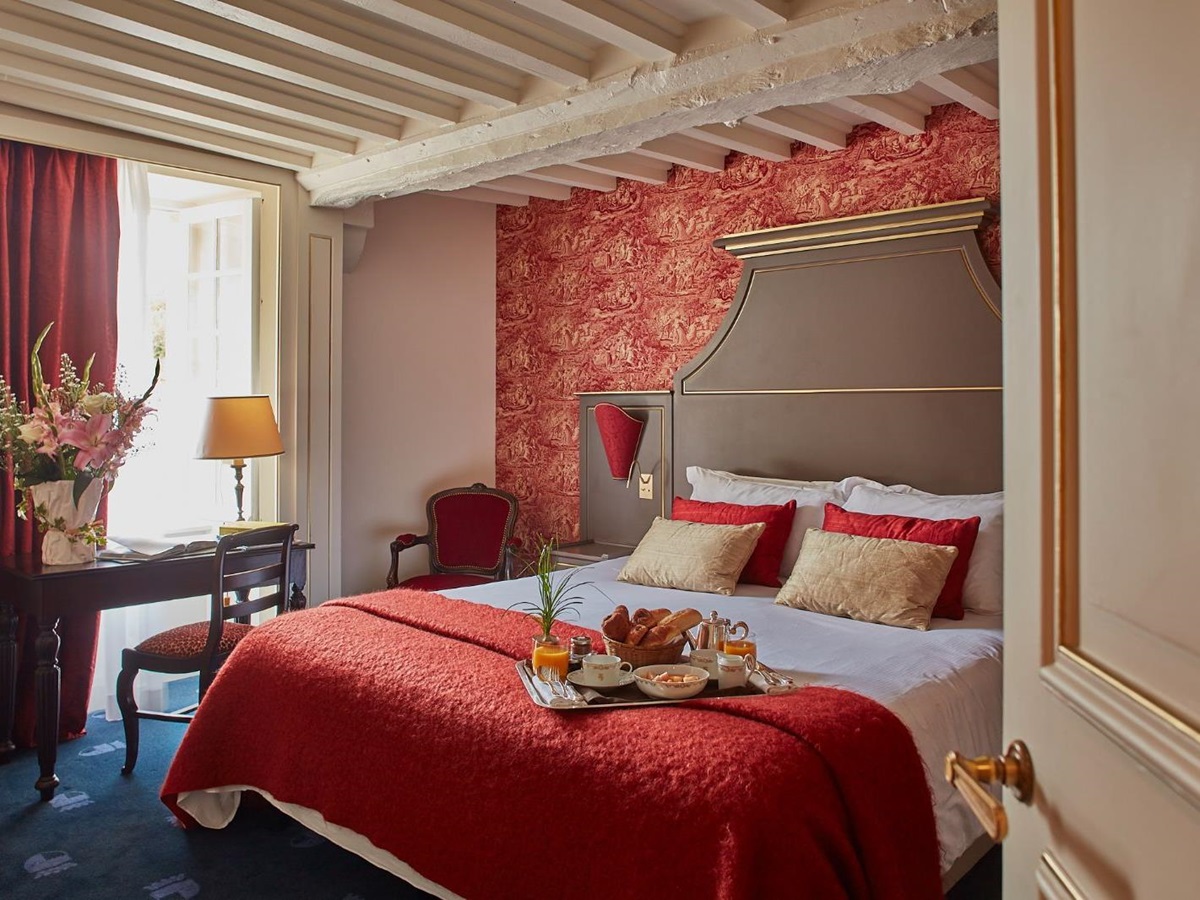 double bed in guest suite at Chateau d'Audrieu in the Normandy region of France