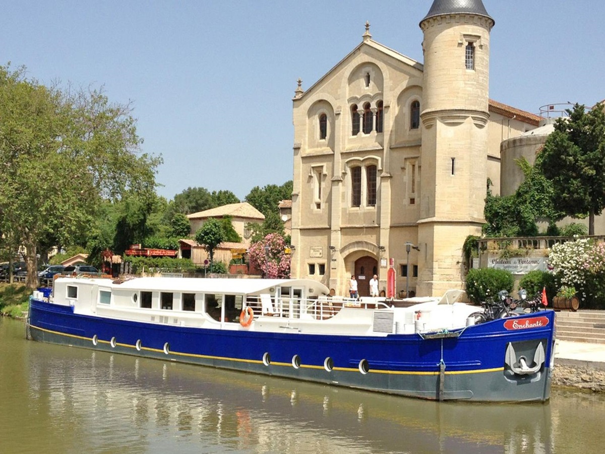 The Enchante barge passing through a town in rural France