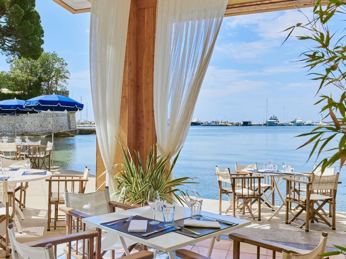 Waterside dining at Hotel Belles RIves on the Cote d'Azur in France