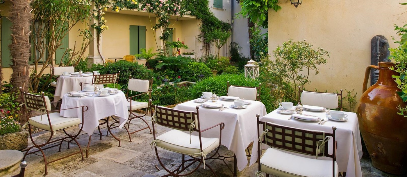 Tables set in a beautiful courtyard at Hotel de Toiras