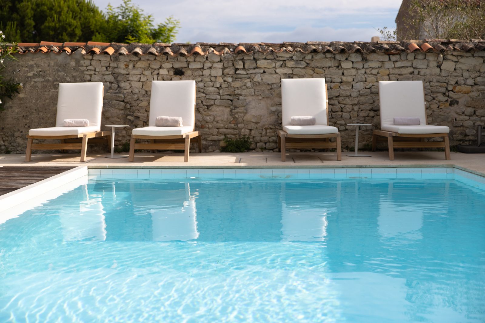 Pool and sun loungers at luxury Hotel de Toiras's sister property in France