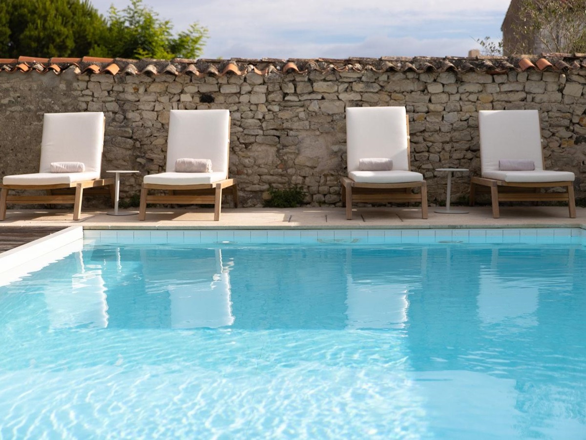 Pool and sun loungers at luxury Hotel de Toiras's sister property in France