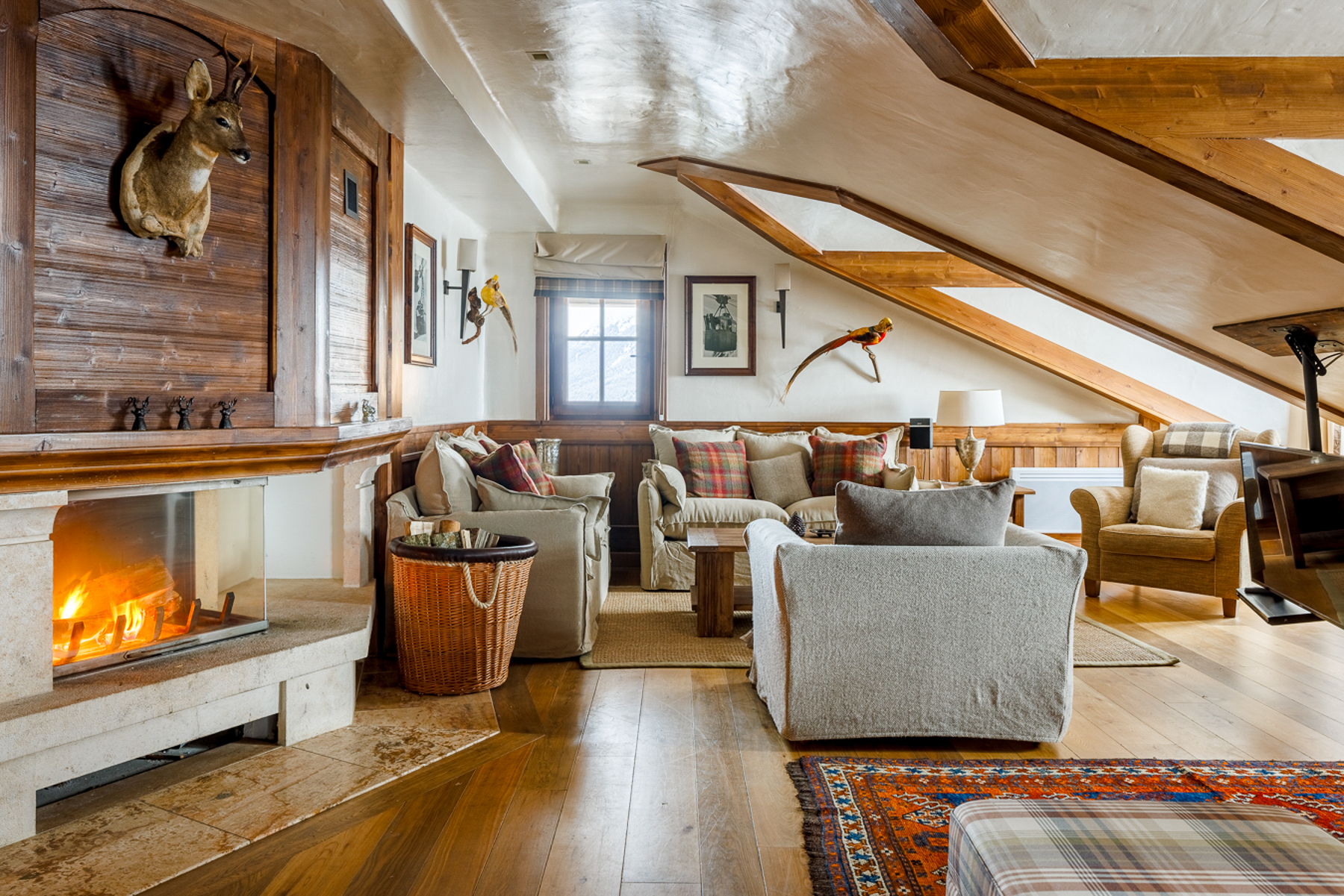 Lounge and fireplace at Hotel Le Portetta in Courchevel