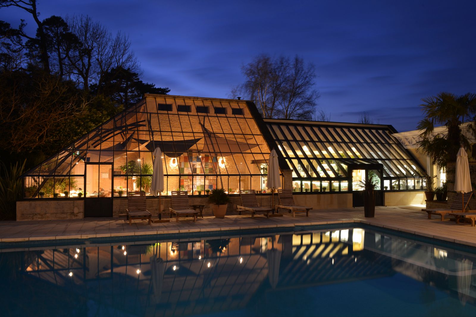 Poolside at night at Chateau La Cheneviere in the Normandy region of France