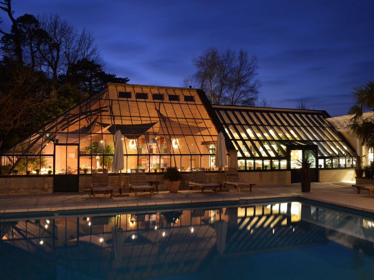 Poolside at night at Chateau La Cheneviere in the Normandy region of France