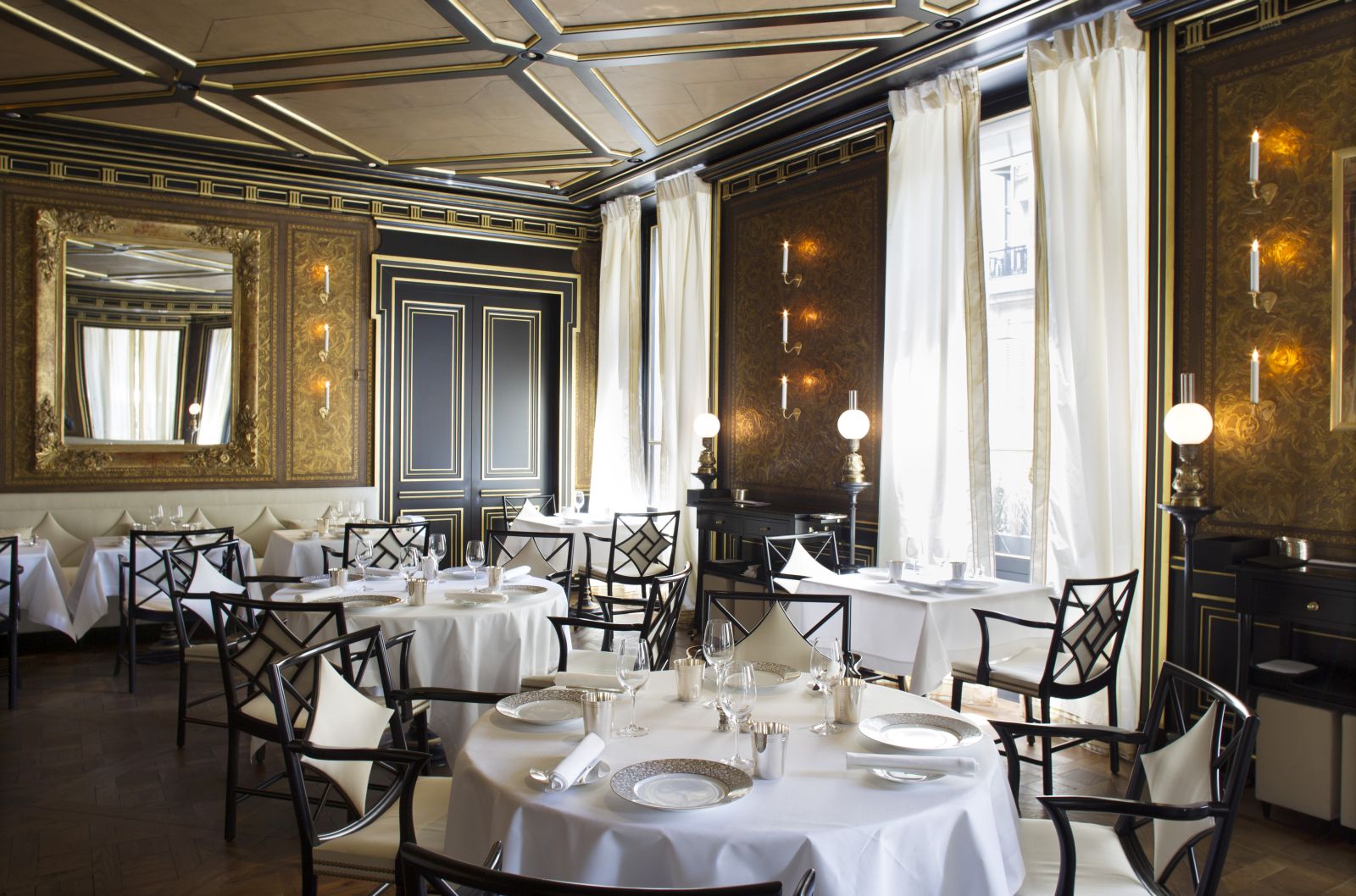 tables set for dinner in the restaurant at La Reserve Hotel in Paris