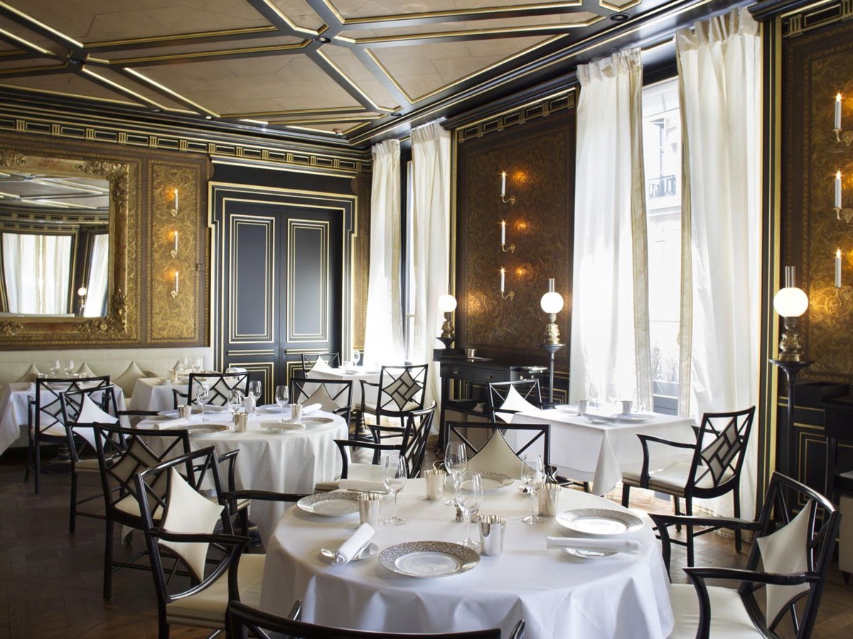 tables set for dinner in the restaurant at La Reserve Hotel in Paris