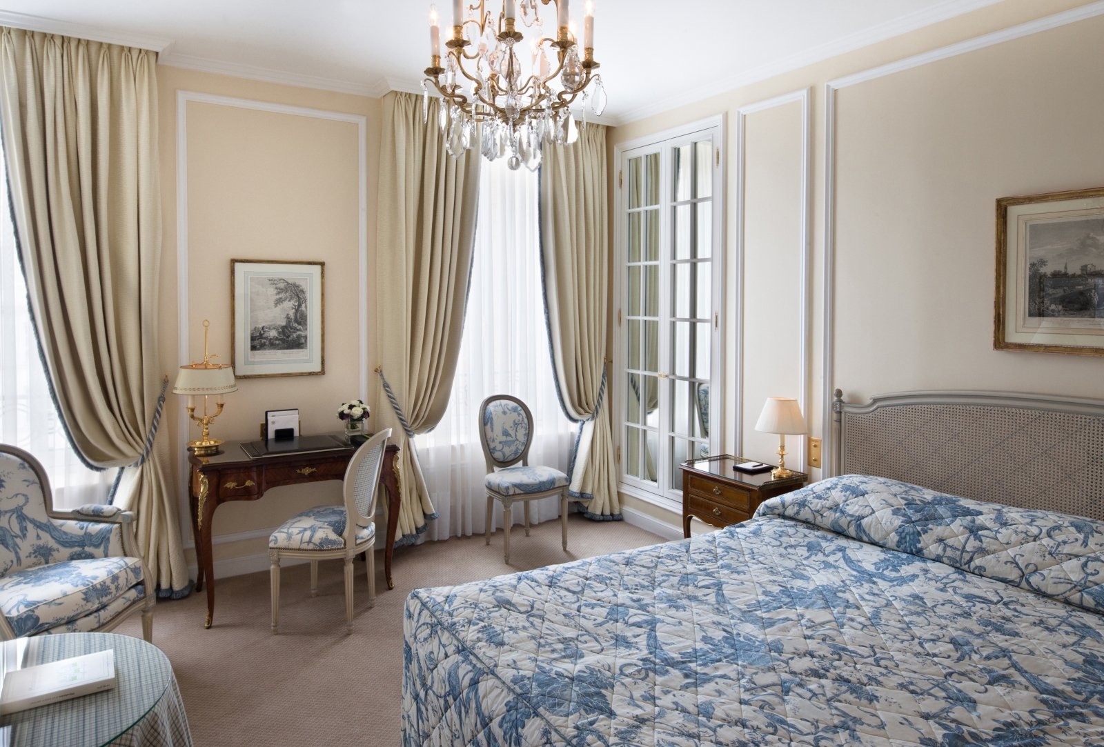A deluxe room at luxury hotel Le Bristol in Paris, France with light blue accents in a creme colour palette