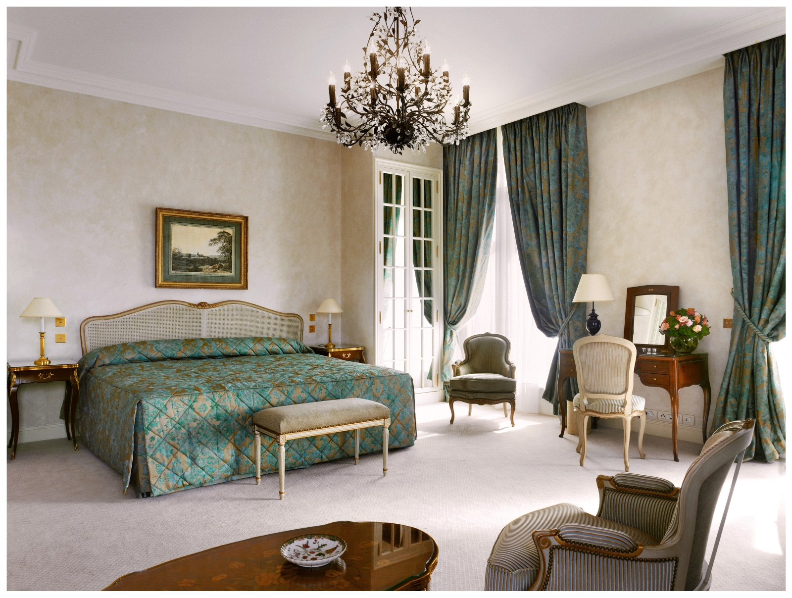 Junior Suite with grande chandelier and rich curtains at luxury hotel Le Bristol in Paris, France