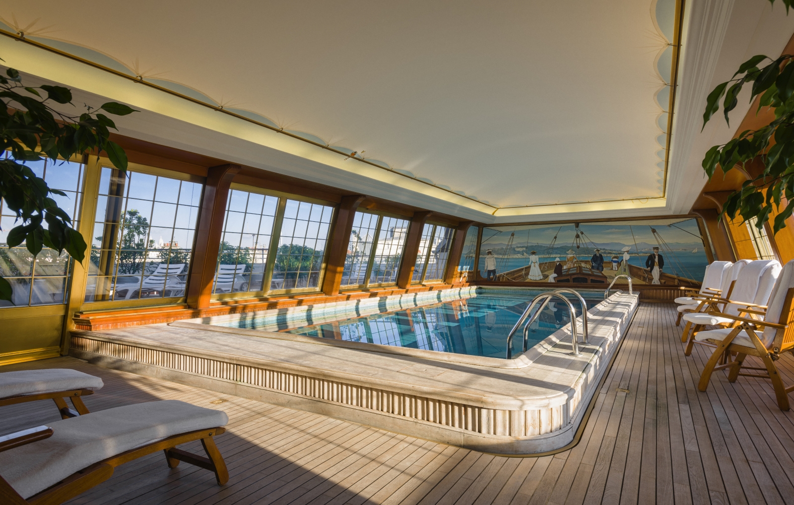 Indoor pool with big windows and a nautical mural at luxury hotel Le Bristol in Paris, France