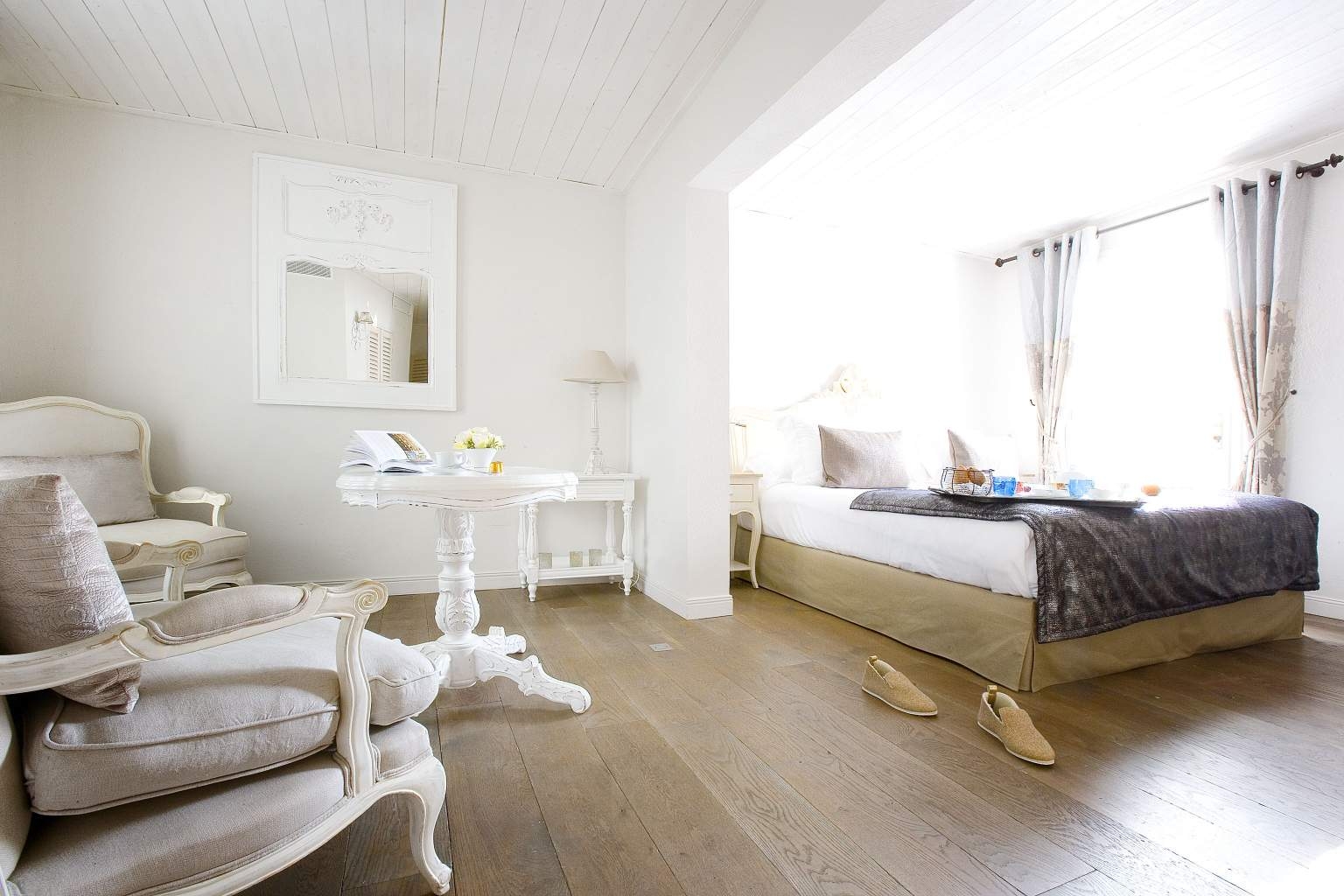 Open airy white bedroom at Le Clos Saint-Martin and Spa in France