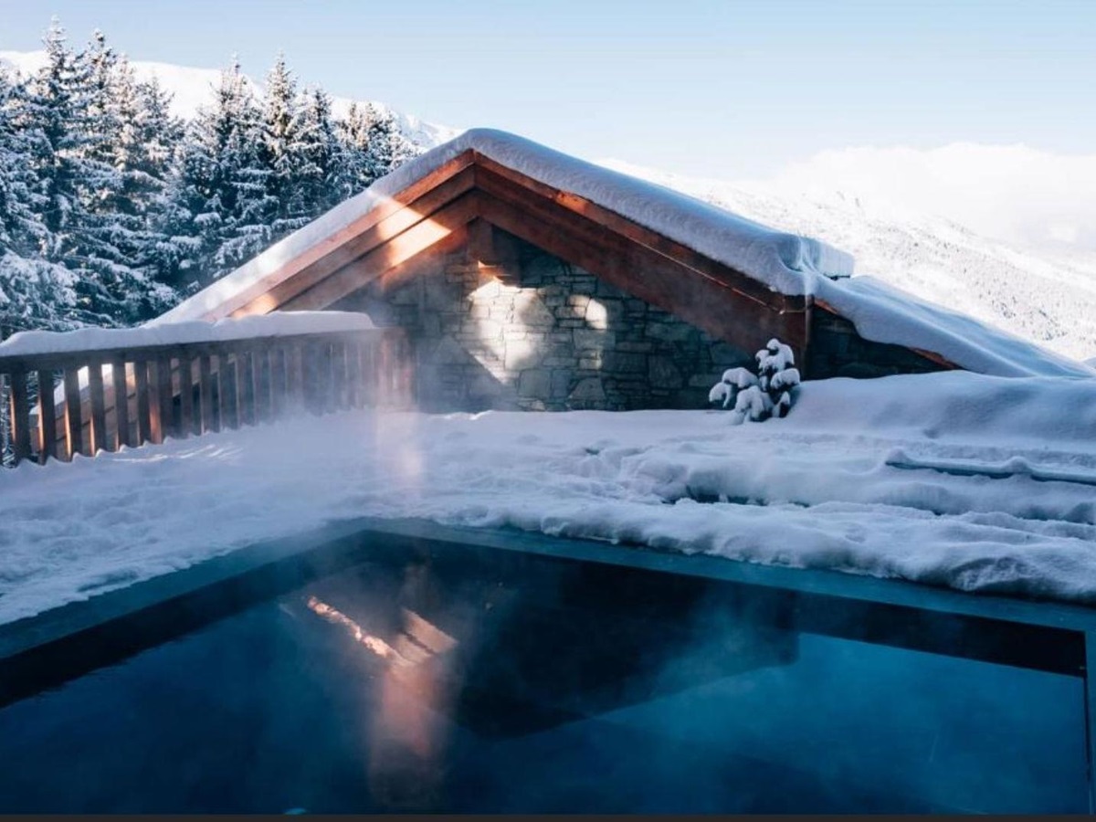 Outdoor swimming pool at Le CouCou hotel in Meribel
