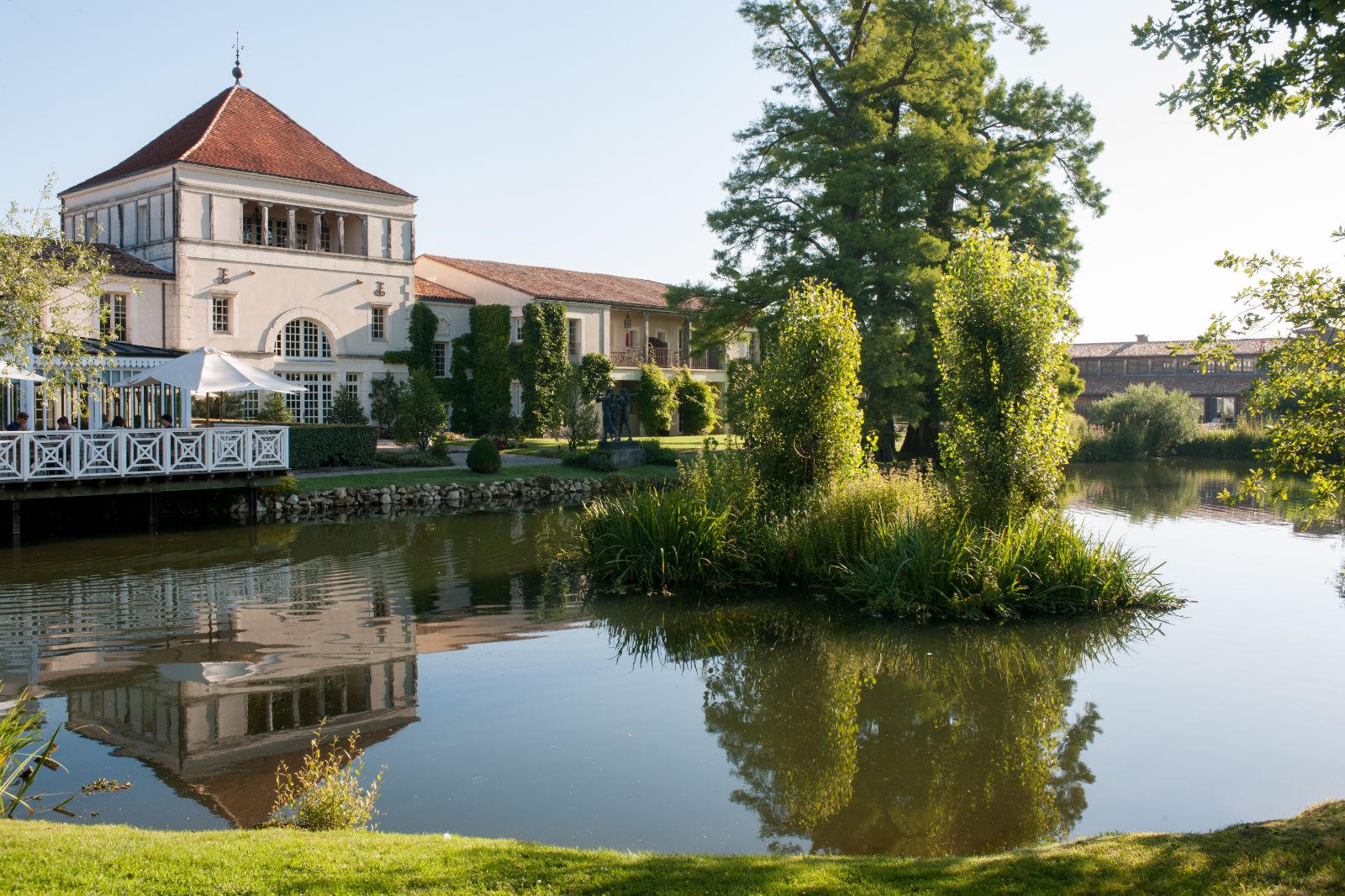 Exterior pond view of La Grand'Vigne restaurant at Les Sources de Caudalie in South West France