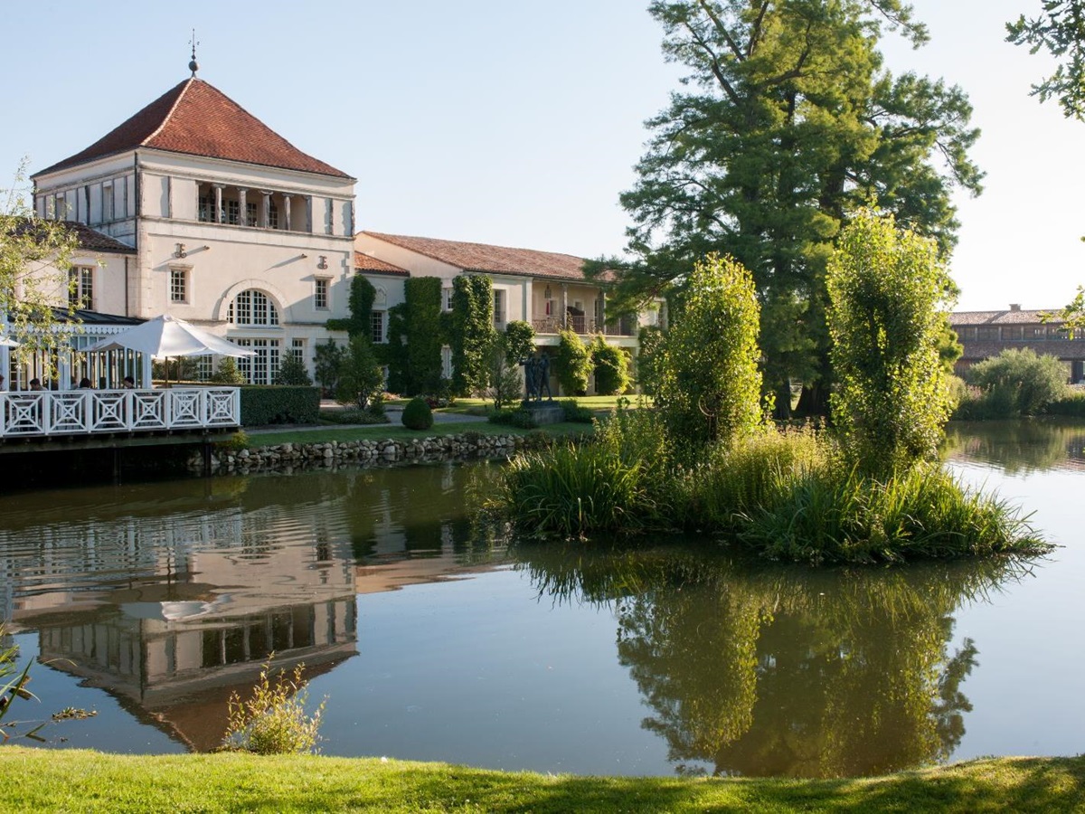 Exterior pond view of La Grand'Vigne restaurant at Les Sources de Caudalie in South West France